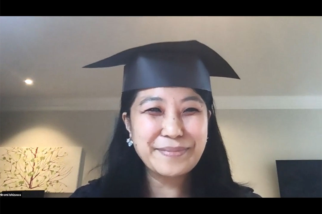 Sociology Department chair wearing a graduation cap and talking on a video chat