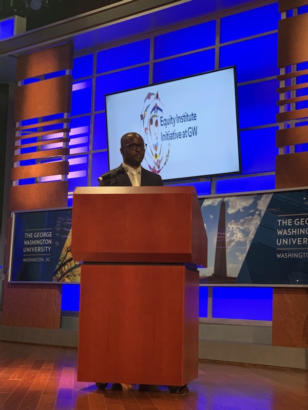 Antwan Jones presenting in front of a blue screen