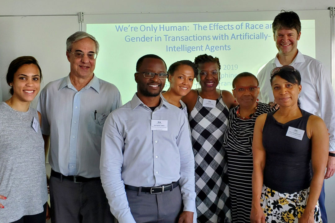 A group of GW Sociology faculty and others standing together in front of a PowerPoint