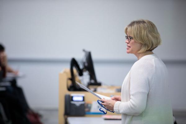 Daina Eglitis standing at the front of a classroom lecturing