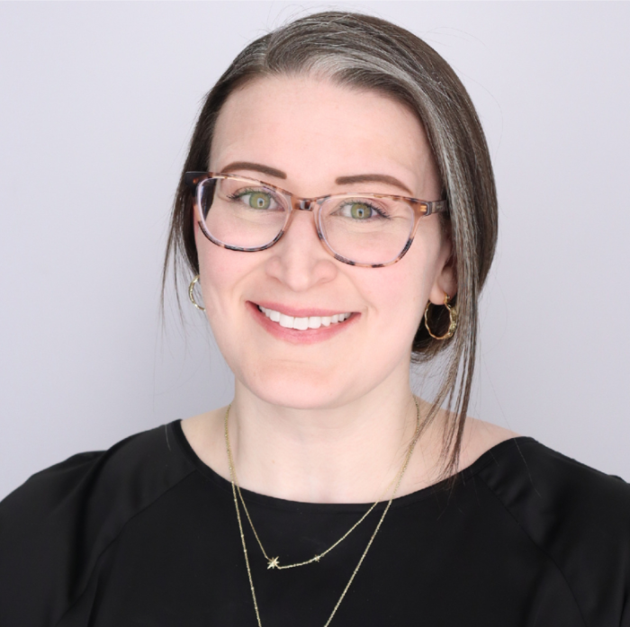 Lauryn King is a white woman with brown glasses and brown/gray hair 