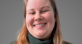 Marissa Mowers, a white woman, poses in a green sweater 